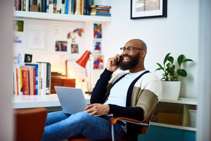 https://www.twice.com/wp-content/uploads/2021/07/Cheerful-man-working-from-home-Getty-Images-726x484.jpg
