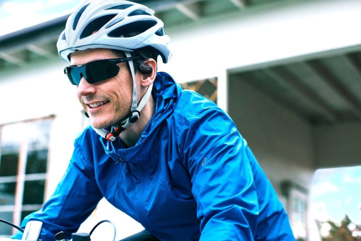 Man enjoying Nearphones on a bicycle