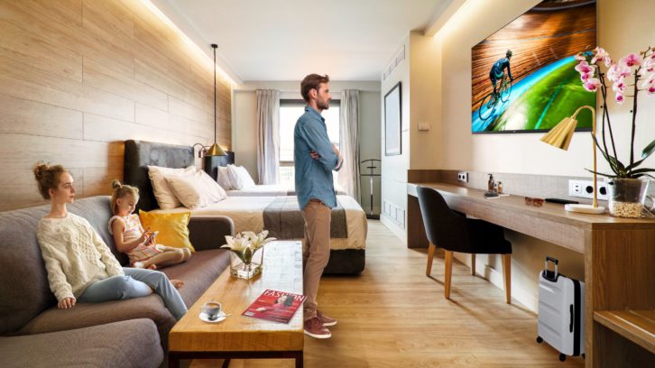 Man standing in hotel room with MediaSuite