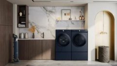 Dark Samsung washer and dryer next to eachother in contemporary home