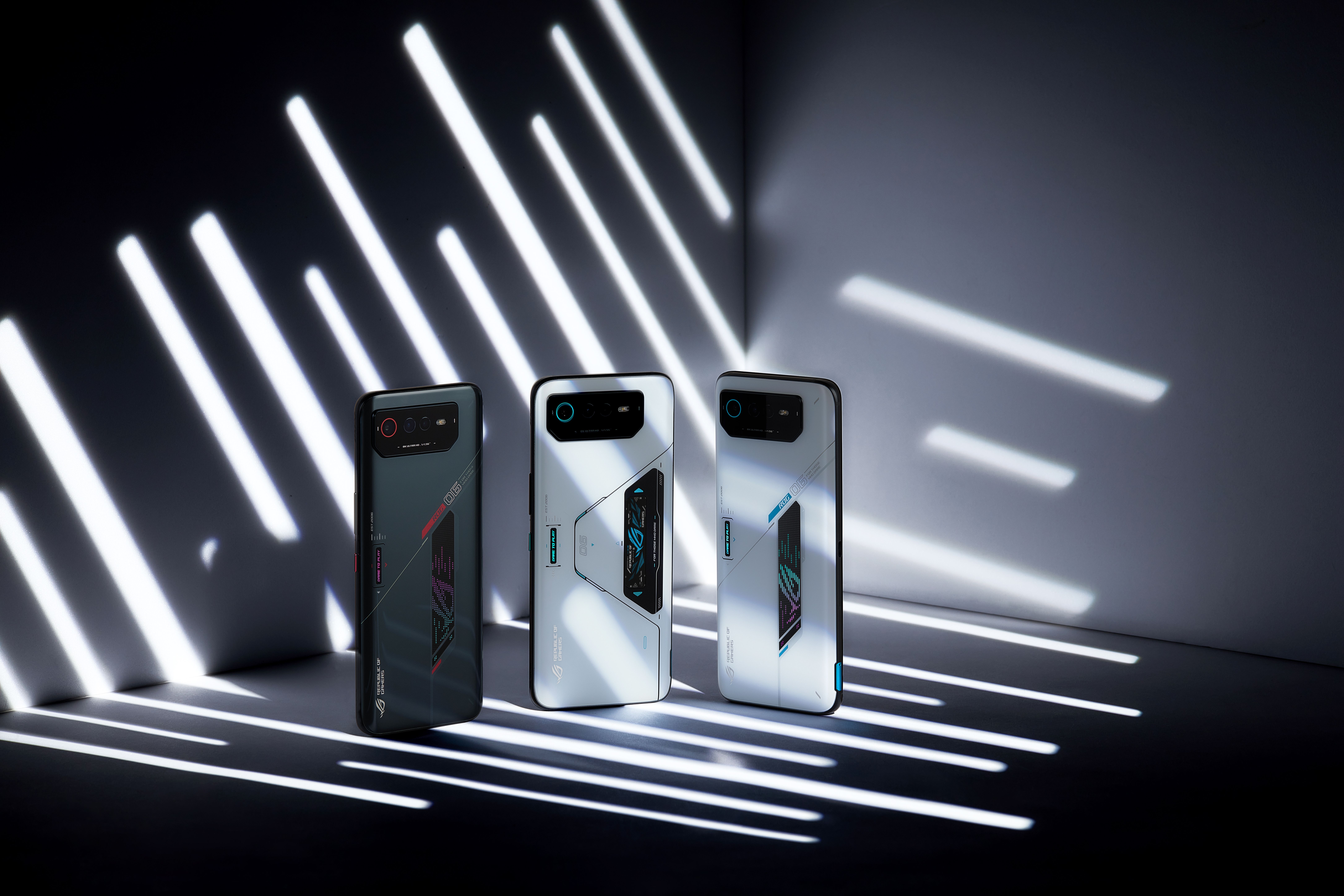 Thre different Rog 6 phones standing in artistic shadows