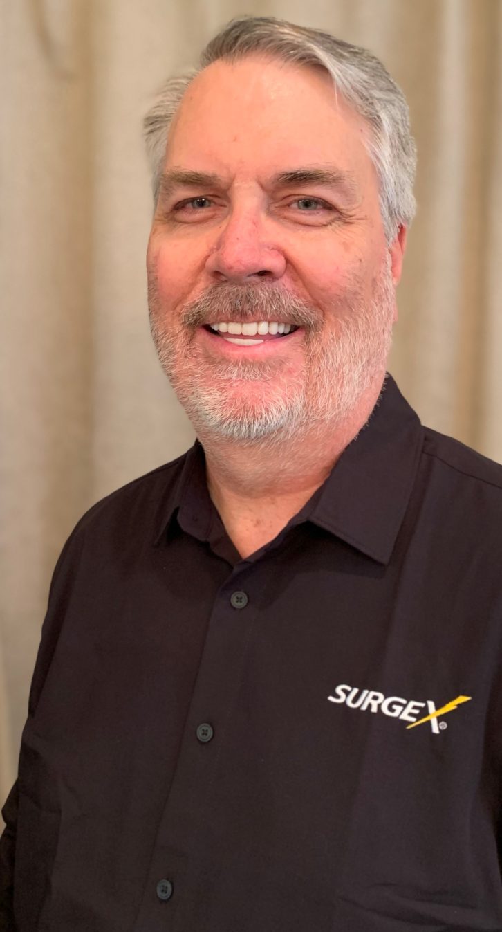 Jeff Mackey, new Sales Application Engineer at SurgeX, wears a black polo shirt with the SurgeX lightning logo. 